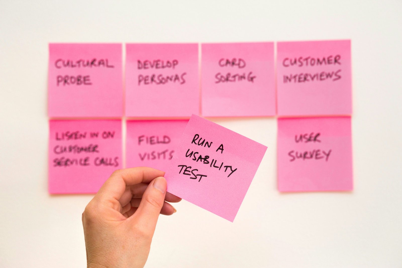 sticky notes for ux design service showcasing run a usability testing text on a pink sticky note